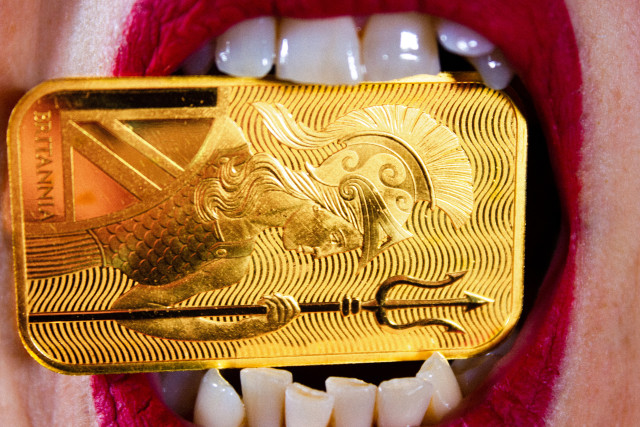 a mouth, with red lipstick. Between the teeth an ounce of gold.